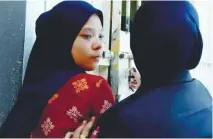  ?? BBXPIX ?? Muhammad Rayyan's mother being led to the magistrate's court for proceeding­s yesterday.