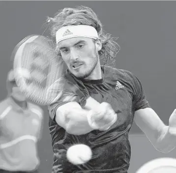  ?? MARTA LAVANDIER/AP ?? Stefanos Tsitsipas hits the ball against Damir Dzumhur during the Miami Open on Saturday.