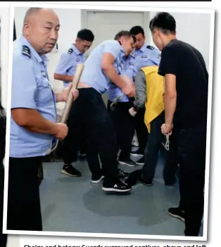  ?? ?? Chains and batons: Guards surround captives, above and left. Below: Women in numbered vests line up for ‘re-education’