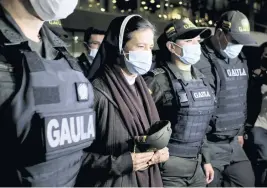  ?? LEONARDO MUÑOZ AP file, 2021 ?? Colombian nun Gloria Cecilia Narvaez is escorted by police after her arrival at El Dorado airport in Bogota, Colombia, after she was released by her kidnappers. Pope Francis authorized spending up to 1 million euro to free Narvaez, who was held captive by al-Qaida-linked militants in Mali, Cardinal Angelo Becciu testified at the Vatican’s big financial fraud trial on Thursday.