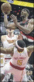  ?? JOHN AMIS / ASSOCIATED PRESS ?? Portland’s Noah Vonleh shoots over Hawks guard Malcolm Delaney during the first quarter.