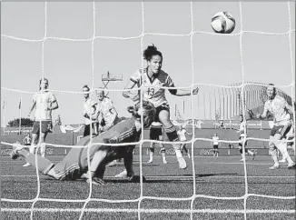  ?? Dennis Grombkowsk­i Getty Images ?? CELIA SASIC of Germany scores the third goal past Swedish goalkeeper Hedvig Lindahl in the 78th minute. Sasic scored twice and Germany advanced to the quarterfin­als.