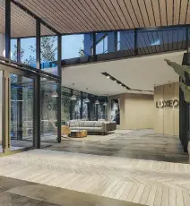  ??  ?? Abundant windows and patterned flooring adds to the airy, contempora­ry feel of Luxeo’s lobby.