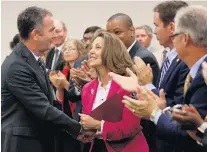  ?? STEVE HELBER/ASSOCIATED PRESS ?? Virginia Gov. Ralph Northam, left, greets his wife, Pam, after delivering his budget update in 2019. The Northams tested positive for COVID-19.