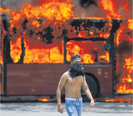  ?? Photo / AP ?? Anti-government protesters have caused chaos in Caracas but have failed to topple Nicolas Maduro.