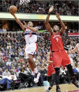  ??  ?? WASHINGTON: Washington Wizards guard Bradley Beal (3) goes to the basket against Toronto Raptors forward Serge Ibaka (9) during the second half of an NBA basketball game, Friday, in Washington. The Raptors won 114-106. —AP