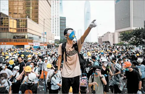  ?? ANTHONY KWAN/GETTY ?? A protester in Hong Kong gestures at a rally Wednesday against an extraditio­n law.