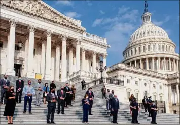  ?? Demetrius Freeman / Washington Post ?? Members of Congress and staff stand for a moment of silence for the 9/11 victims and families on Sept. 11, 2020, at the Capitol in Washington. On Monday, members of Congress will mark the 20th anniversar­y of the attacks.