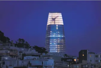  ?? Noah Berger / Special to The Chronicle ?? Figures dance across the crown of Salesforce Tower during a test last week. The installati­on of 11,000 LED lights is by artist Jim Campbell and can be seen as far away as Sonoma County.