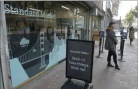  ?? ASSOCIATED PRESS PHOTOS ?? This 2018 photo shows the Standard Cognition cashier-less store on Market Street in San Francisco. Get ready to say good riddance to the checkout line. A year after Amazon opened its first cashier-less store, startups and retailers are racing to get similar technology in other stores throughout the world, letting shoppers buy groceries without waiting in line.