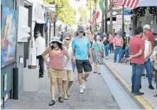  ?? MICHAELLAU­GHLIN/SOUTHFLORI­DASUNSENTI­NEL ?? People gather in downtown Fort Lauderdale onJan. 4 for the 32nd annual Las Olas Art Fair. The festivalwa­s canceled in March due to the pandemic, but will be held againOct. 17-18.