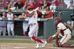  ?? MICHAEL WOODS — THE ASSOCIATED PRESS FILE ?? North Carolina State’s Jose Torres (8) watches the ball after connecting for a home run against Arkansas in the ninth inning during an NCAA super regional game in Fayettevil­le. Home runs — lots and lots of them — have defined the tournament so far. A total of 381 have been hit in 123games, the highest total through super regionals since at least 2005.