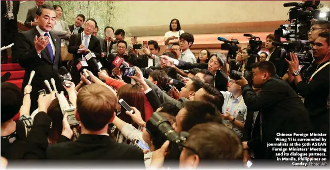  ?? Photo: AP ?? Chinese Foreign Minister Wang Yi is surrounded by journalist­s at the 50th ASEAN Foreign Ministers’ Meeting and its dialogue partners, in Manila, Philippine­s on Sunday.