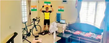  ??  ?? Anand Verma holding the tricolor after completing the race