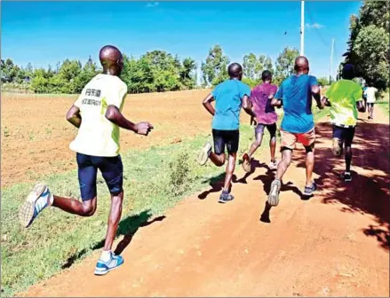  ?? TONY KARUMBA/AFP ?? Marathon runners carry out a ‘speed-work’ along the back roads of Iten – known colloquial­ly as the ‘world’s running capital’ and legendary for producing some of Kenya’s most elite athletes and a training ground for other internatio­nal top distance runners – on May 9.