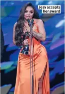  ??  ?? Jesy accepts her award