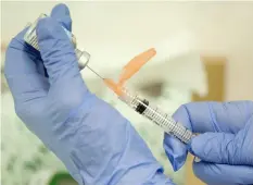  ?? EVAN VUCCI/AP ?? A nurse practition­er prepares a flu vaccinatio­n in Rockville, Md.