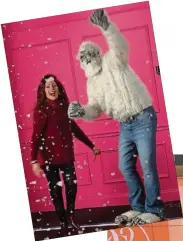  ??  ?? It’s fun here: Fake snow falls as Diane Gilman dances with a Yeti wearing her DG2 jeans.
