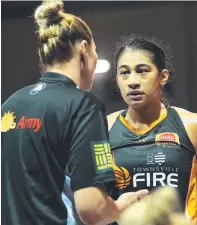  ?? Sidelined Fire captain Suzy Batkovic ( advice to young teammate Zitina Aokuso. hands out ?? left)