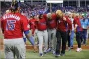  ?? DAVID SANTIAGO - MIAMI HERALD VIA AP ?? Puerto Rico's Edwin Diaz is helped off the field after injuring his knee following his team's win to advance in the WBC.