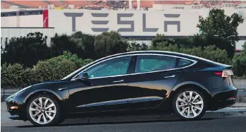  ?? TESLA MOTORS VIA AP FILES ?? Tesla is burning more than US$1 billion a quarter due to its costly investment in making the Model 3. The company says it’s ramping up output of its Model 3 to bring in cash.