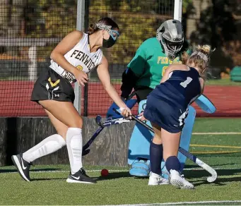  ?? STuART cAHiLL PHoTos / HeRALd sTAFF ?? SNEAKS THROUGH: Kate Cunning just beats Bishop Fenwick goalie Cat Eliase.