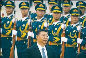  ?? AP/MARK SCHIEFELBE­IN ?? China’s President Xi Jinping reviews an honor guard Wednesday during a welcome ceremony for Brunei’s Sultan Hassanal Bolkiah at the Great Hall of the People in Beijing.