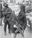  ??  ?? Security forces stand outside the kosher market in Paris where four hostages were killed on Friday. Israeli Prime Minister Benjamin Netanyahu visited the site on Monday.