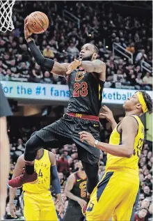  ?? TONY DEJAK THE ASSOCIATED PRESS ?? Cleveland Cavaliers’ LeBron James (23) drives to the basket against Indiana Pacers’ Myles Turner in the first half. Cleveland won, 105-101.