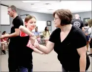  ?? LYNN KUTTER ENTERPRISE-LEADER ?? Heather Laster of Belleville in western Yell County, works on techniques with her daughter Caitlyn Laster that she could use if someone tried to attack her. Laster was one of about 15 visually impaired students who participat­ed in a self-defense class...