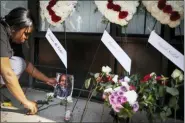  ?? JOHN MINCHILLO — THE ASSOCIATED PRESS ?? Jamila McNichols, sister of slain mass shooting victim Thomas “TJ” McNichols, mourns beside a memorial near the scene of the mass shooting Monday in Dayton.