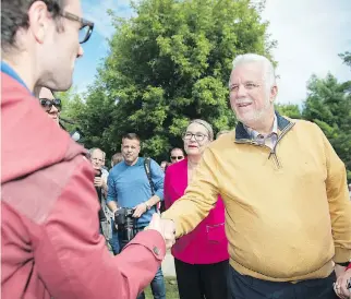 ?? GRAHAM HUGHES/THE CANADIAN PRESS ?? Liberal Party Leader Philippe Couillard greets supporters at a campaign stop in Coteau-du-Lac on Sunday, where he repeated his belief in Quebec as a “welcoming place.”