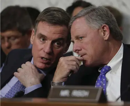  ?? aP File ?? INSIDER TRADING? Senate Intelligen­ce Committee Chairman Sen. Richard Burr, R-N.C., right, confering with Mark Warner, D-Va., in Washington, during a hearing in 2017, has stepped down from his chairmansh­ip as the FBI probes the sale of stock he made as the coronaviru­s epidemic hit.