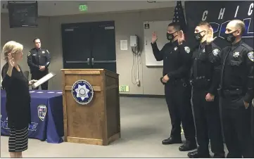  ?? WILL DENNER — ENTERPRISE-RECORD ?? Chico City Clerk Debbie Presson, left, swears in Chico Police Department officers, from left to right, Juan Jose Valencia, Timothy Simpson and Michael Vincent, while Police Chief Matt Madden, second from left, looks on Thursday in Chico.