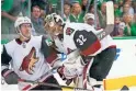  ??  ?? Coyotes goaltender Antti Raanta (32) checks on defenseman Jordan Oesterle after Oesterle was hit during the second period against the Stars on Thursday in Dallas.