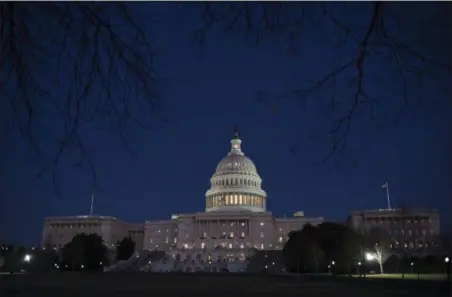  ?? J. SCOTT APPLEWHITE — THE ASSOCIATED PRESS ?? With no apparent indication­s of a breakthrou­gh in the Senate to avoid a government shutdown, the Capitol is illuminate­d in Washington, Friday evening.