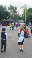  ??  ?? Jan White, Mary Daly, head teacher Iain Witts, Marie Russell and Jade Farrin at the opening and right; pupils dancing round the maypole