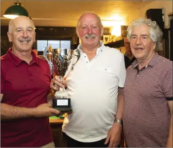  ??  ?? John Kehoe presents the Jim O’Neill Cup to John Nolan (winner) as Michael Lee, Captain of the Three Bullet Gate Golf Society in New Ross, looks on.