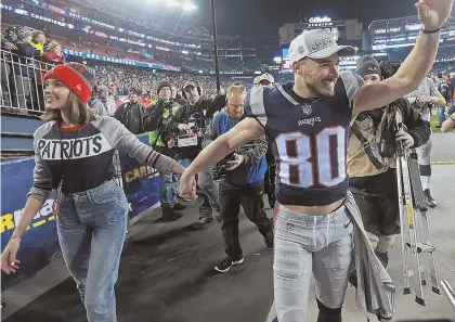  ?? STAFF PHOTO BY MATT STONE ?? Olivia Culpo and Pats wide receiver Danny Amendola celebrate at yesterday’s AFC Championsh­ip game.