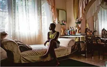  ?? AFP ?? Rosita Mabuiango, who 17 years ago was born in a tree during floods in Mozambique in 2000, sitting in her lounge in Maputo. Rosita was born on March 1, 2000, four days after her marooned mother clambered into a tree to escape deadly floods.