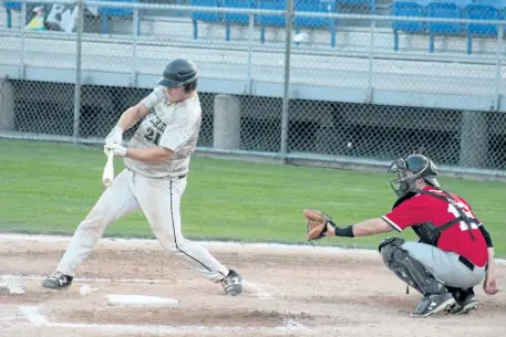  ?? COREY LEBLANC/SPECIAL TO POSTMEDIA NEWS ?? Fort Erie Cannons starting catcher Robin Kellar (left) hits a ball on the ground in his game against the Merritton Alliance on Wednesday night. Also pictured is Alliance starting catcher Mark Fusco, who collected a hit for his team in the 10-5 loss.