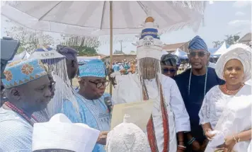  ?? ?? Ogun State Commission­er for Local Government and Chieftainc­y Affairs, Ganiyu Hamzat ( left); the new Olofin of Ado – Odo, Oba Olushola Lamidi Osolo ( middle) and member representi­ng Ado - Odo/ Ota, Tunji Akinosi at the presentati­on of Staff of Office to Oba Osolo in Ado - Odo/ Ota, Ogun State… yesterday