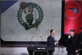  ?? FRANK FRANKLIN II THE ASSOCIATED PRESS ?? NBA Deputy Commission­er Mark Tatum, left, watches as Boston Celtics co‑owner Wyc Grousbeck reacts after learning the Celtics had won the first pick in the NBA basketball draft on May 16 in New York.