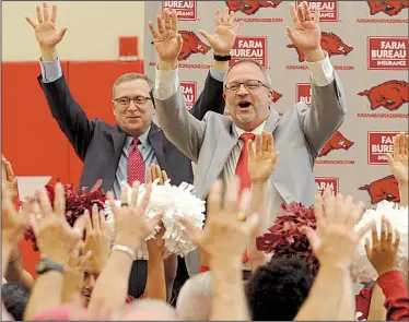  ?? NWA Democrat-Gazette/ANDY SHUPE ?? Arkansas Razorbacks Athletic Director Jeff Long (left) joins Mike Neighbors in doing the Hog Call with several supporters during a news conference to introduce Neighbors as the school’s new women’s basketball coach Tuesday at the university’s...