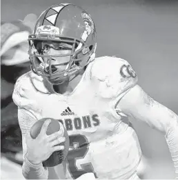  ?? MICHAEL LAUGHLIN/SUN SENTINEL ?? Cardinal Gibbons quarterbac­k Nik Scalzo runs for a first down against McArthur during the second half of their game, on Nov. 2 at McArthur High School.