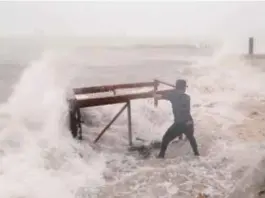  ??  ?? A man tries to salvage a table belonging to his restaurant before the arrival of Maria in Punta Cana, Dominican Republic on Wednesday.