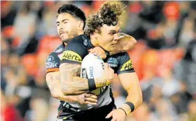  ?? Photo / Photosport ?? Shaun Johnson tackles James Fisher-Harris in the Panthers game last Friday night.