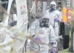  ?? AP ?? Personnel in protective gear work on a van in Winterslow, England, as investigat­ions continue into the nerve-agent poisoning of Russian ex-spy Sergei Skripal.