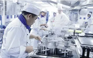  ??  ?? ( Top) A new intake of Le Cordon Bleu Malaysia students at their Orientatio­n Day. ( Left pic) Students learning the craft of cooking in a state- of- theart kitchen.