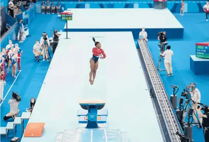  ?? DOUG MILLS/THE NEW YORK TIMES ?? Simone Biles, of the United States, competes in vault during the women’s team gymnastics final Tuesday at the Olympic Games in Tokyo.